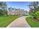 Two-story house with a large driveway and landscaping at 753 Renegade Ln, Port Orange, FL 32127