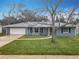 Gray house with white garage door, landscaped lawn, and driveway at 925 Mill Road Ln, Port Orange, FL 32127