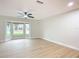 Bright living room featuring hardwood floors, bay window, and ceiling fan at 925 Mill Road Ln, Port Orange, FL 32127