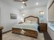 Bright bedroom with king bed, neutral tones and wood flooring at 1175 Celadon St, Oakland, FL 34787