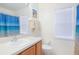 Clean bathroom with wood cabinets and blue shower curtain at 119 Rockhill Dr, Sanford, FL 32771