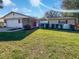 House exterior with a well maintained lawn at 1319 N Old Mill Dr, Deltona, FL 32725