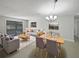 Bright living room features gray sofas, wood coffee table, and dining area at 1319 N Old Mill Dr, Deltona, FL 32725