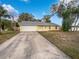 Cute yellow house with a white garage door and a spacious yard at 1350 Bailey Ave, Deltona, FL 32725