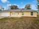 House exterior showcasing a manicured lawn and driveway at 1350 Bailey Ave, Deltona, FL 32725