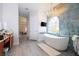 Luxurious bathroom with soaking tub, walk-in shower, and chandelier at 14039 Hampshire Bay Cir, Winter Garden, FL 34787