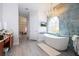 Luxurious bathroom with soaking tub, walk-in shower, and chandelier at 14039 Hampshire Bay Cir, Winter Garden, FL 34787