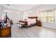 Bright bedroom featuring a king bed, hardwood floors, and ample natural light at 14039 Hampshire Bay Cir, Winter Garden, FL 34787