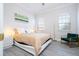 Bright bedroom with a comfortable bed and stylish chair at 14039 Hampshire Bay Cir, Winter Garden, FL 34787