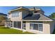 Rear view of a house with solar panels and screened-in patio at 14039 Hampshire Bay Cir, Winter Garden, FL 34787
