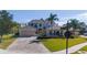 Two-story home with manicured lawn, brick driveway, a two-car garage and lush, green landscaping at 14039 Hampshire Bay Cir, Winter Garden, FL 34787