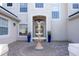 Elegant entryway with a tiered fountain and blue planters at 14039 Hampshire Bay Cir, Winter Garden, FL 34787