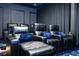 Home theater with multiple recliner seats and a themed carpet at 14039 Hampshire Bay Cir, Winter Garden, FL 34787