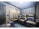 Home theater with black leather recliners and a large projection screen at 14039 Hampshire Bay Cir, Winter Garden, FL 34787