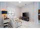 Relaxing living room with large TV and comfortable seating at 14039 Hampshire Bay Cir, Winter Garden, FL 34787