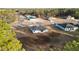 A high shot that shows the home's placement on a manicured lot surrounded by a lush tree line at 14735 Sw 69Th Court Rd, Ocala, FL 34473