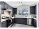 Modern kitchen with dark cabinets and white quartz countertops at 14850 Lady Victoria Blvd, Orlando, FL 32826