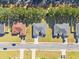 Aerial view of three houses on a tree-lined street at 162 Nw 42Nd Pl, Ocala, FL 34475