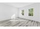 Bright bedroom featuring wood-look floors and large windows at 162 Nw 42Nd Pl, Ocala, FL 34475