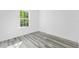 Bright bedroom with grey wood-look flooring and large window at 162 Nw 42Nd Pl, Ocala, FL 34475