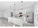 Modern kitchen with white cabinets and stainless steel appliances at 162 Nw 42Nd Pl, Ocala, FL 34475