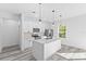 Modern kitchen with white cabinets, island, and stainless steel appliances at 162 Nw 42Nd Pl, Ocala, FL 34475