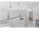 Open concept kitchen features a large island and white cabinetry at 162 Nw 42Nd Pl, Ocala, FL 34475