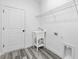 Bright laundry room with a utility sink and storage shelving at 162 Nw 42Nd Pl, Ocala, FL 34475