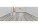 Spacious living room with wood-look floors and large windows at 162 Nw 42Nd Pl, Ocala, FL 34475