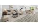 Bright open-concept living room featuring modern decor, wood floors, and a seamless flow to the kitchen and dining area at 162 Nw 42Nd Pl, Ocala, FL 34475