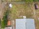 Aerial view showing house, yard, shed, and partially visible street at 164 Brad Cir, Winter Haven, FL 33880