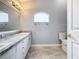 Updated bathroom with double sinks, granite countertops, and large mirror at 164 Brad Cir, Winter Haven, FL 33880