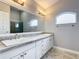 Bathroom boasts double sinks, granite countertop, and modern fixtures at 164 Brad Cir, Winter Haven, FL 33880