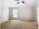 Well-lit bedroom featuring a ceiling fan and carpet flooring at 164 Brad Cir, Winter Haven, FL 33880