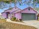 Purple house with gray garage door and landscaping at 164 Brad Cir, Winter Haven, FL 33880