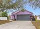 Charming house with a gray garage door and landscaping at 164 Brad Cir, Winter Haven, FL 33880