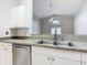 Kitchen features a double sink, granite countertop, and white cabinets at 164 Brad Cir, Winter Haven, FL 33880
