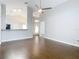 Living room with dark hardwood floors and kitchen view at 164 Brad Cir, Winter Haven, FL 33880