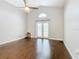 Spacious living room with dark hardwood floors and french doors at 164 Brad Cir, Winter Haven, FL 33880