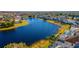 Aerial view of a lakefront community with houses and lush landscaping at 1647 Bridgeview Cir, Orlando, FL 32824