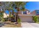 Two-story house with attached garage and landscaping at 1647 Bridgeview Cir, Orlando, FL 32824