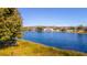 Scenic view of a tranquil lake with lush vegetation at 1647 Bridgeview Cir, Orlando, FL 32824