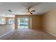 Living room with pool view, ceiling fan, and sliding glass doors at 1647 Bridgeview Cir, Orlando, FL 32824
