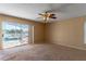 Living room with pool view, ceiling fan, and sliding glass doors at 1647 Bridgeview Cir, Orlando, FL 32824