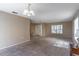 Spacious living room with neutral carpeting and large windows at 1647 Bridgeview Cir, Orlando, FL 32824