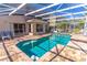 Inviting pool area with screened enclosure and brick pavers at 1647 Bridgeview Cir, Orlando, FL 32824