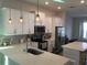 Modern kitchen with white cabinets and island at 1769 White Feather Loop, Oakland, FL 34787