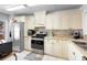 View of a well-lit kitchen with stainless steel appliances and white cabinets at 180 Hill St # 180, Casselberry, FL 32707