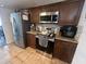 Kitchen area with stainless steel appliances and wood cabinets at 1836 Warringwood Dr # B-4, Orlando, FL 32839