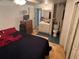 A simple bedroom with a bed, dresser, and a partial view of an attached bathroom at 1960 Pinewood Ln, Mount Dora, FL 32757